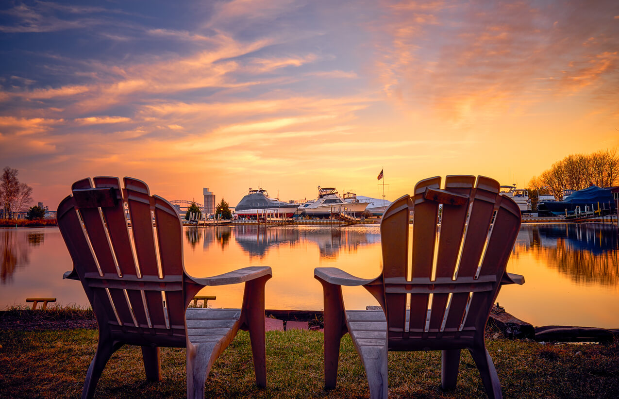 a pair of chairs overlooking Park Point, Duluth during a sunset