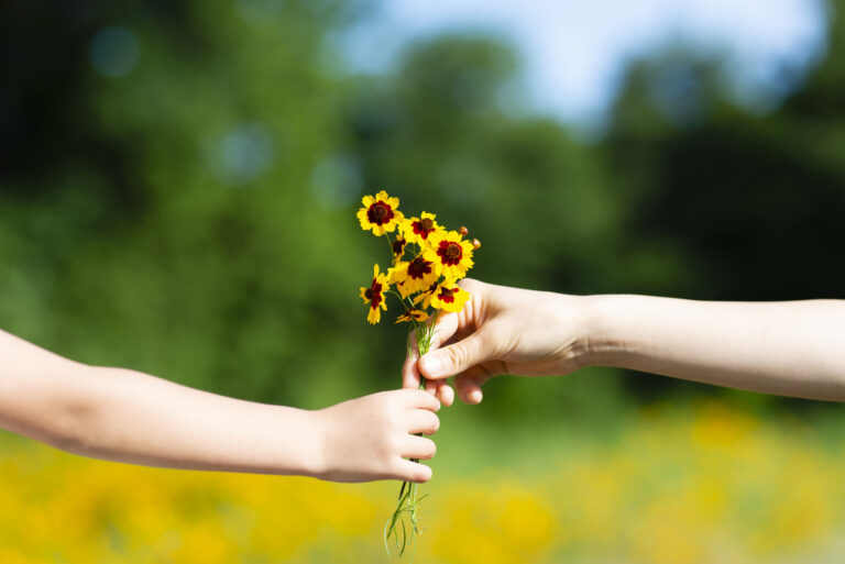 Parents and child give flowers